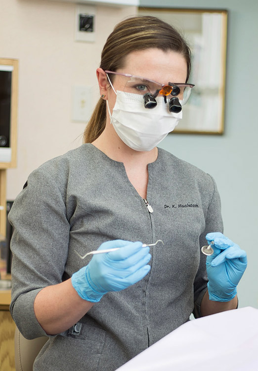 Female dentist with dental tools