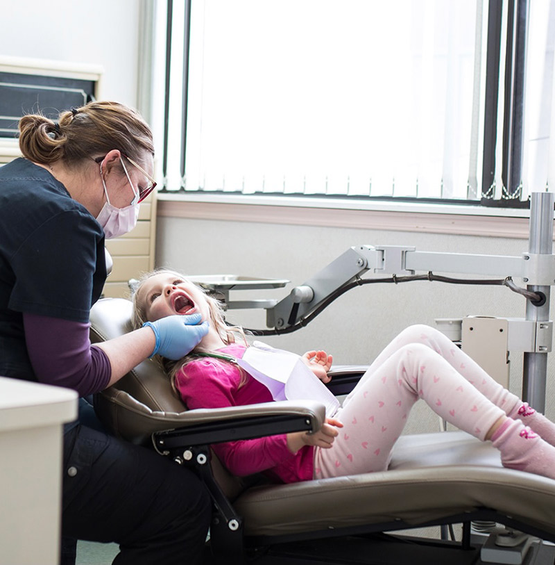 Dental Hygienist with a little girl during checkup